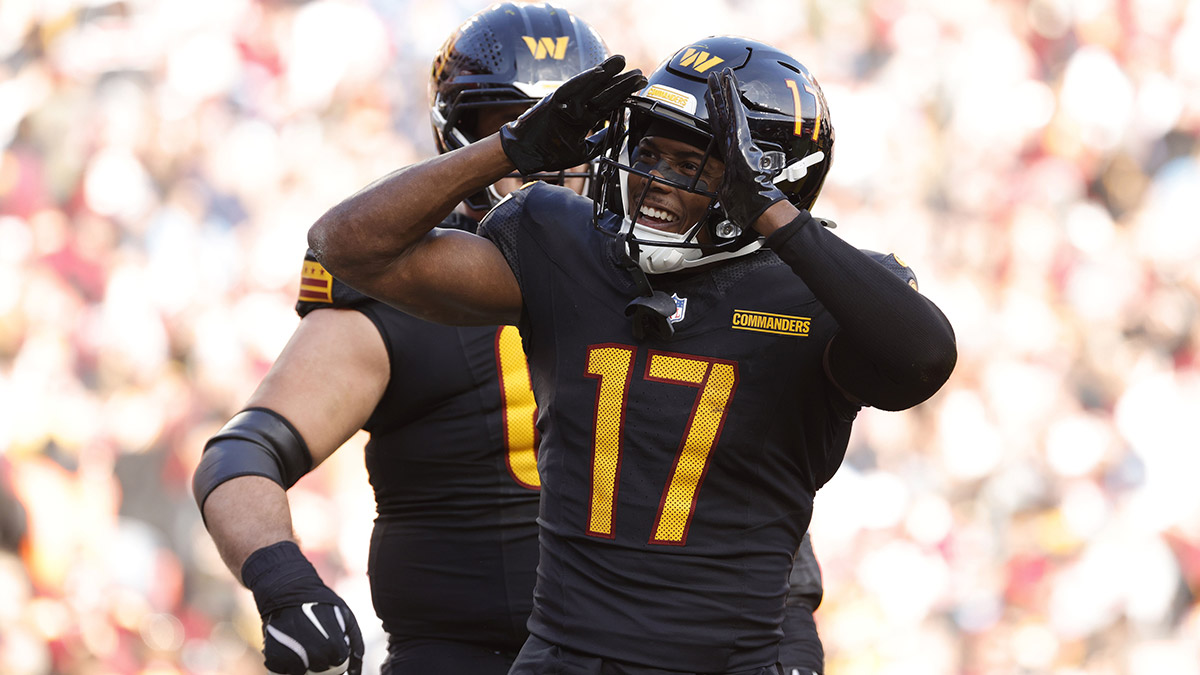 Washington Commanders wide receiver Terry McLaurin (17) celebrates with fans in the stands after scoring a touchdown against Tennessee Titans during the first half at Northwest Stadium.