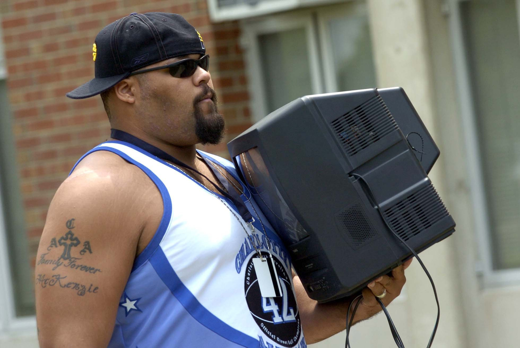 Guard/tackle Aaron Gibson arrives with his TV in 2004.