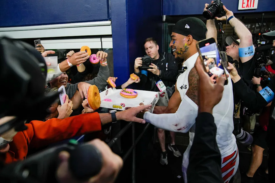 Cincinnati Bengals receiver Ja'Marr Chase gives donuts to fans after the Bengals beat the Dallas Cowboys.