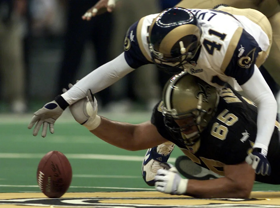 24 Dec 2000: Todd Lyght #41 of the St. Louis Rams and Chris Naeole #65 of the New Orleans Saints compete for a loose ball during the final regular season game at the Louisiana Superdome in New Orleans, Louisiana. Digital Image. The Rams defeated the Saints with a final score of 26-21. Mandatory Credit: Jamie Squire/ALLSPORT