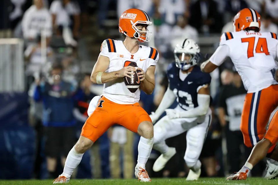 Illinois quarterback Luke Altmyer (9) drops back to throw against Penn State during their game at Beaver Stadium.
