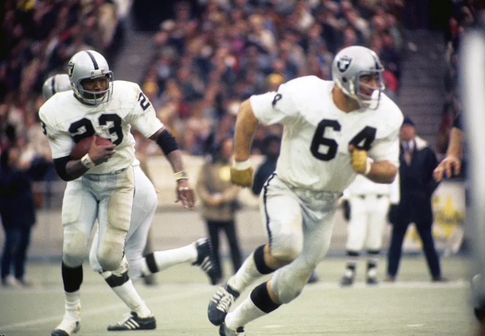 Dec 23, 1972; Pittsburgh, PA, USA; FILE PHOTO; Oakland Raiders guard George Buehler (64) and running back Charlie Smith (23) in action against the Pittsburgh Steelers during the 1972 AFC Divisional Playoff Game at Three Rivers Stadium. The Steelers defeated the Raiders 13-7. Mandatory Credit: Malcolm Emmons-USA TODAY Sports