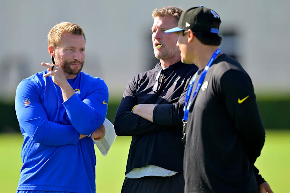 Jul 29, 2024; Los Angeles, CA, USA; Los Angeles Rams head coach Sean McVay, general manager Les Snead and chief of staff Carter Crutchfield talk on the field during training camp at Loyola Marymount University. Jayne Kamin-Oncea-Imagn Images