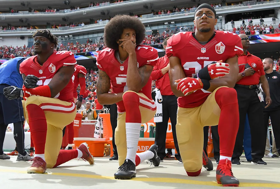 Eli Harold (58), Colin Kaepernick (7) and Eric Reid (35) of the San Francisco 49ers kneel on the sideline during the National Anthem prior to a game in 2016. (Photo by Thearon W. Henderson/Getty Images)