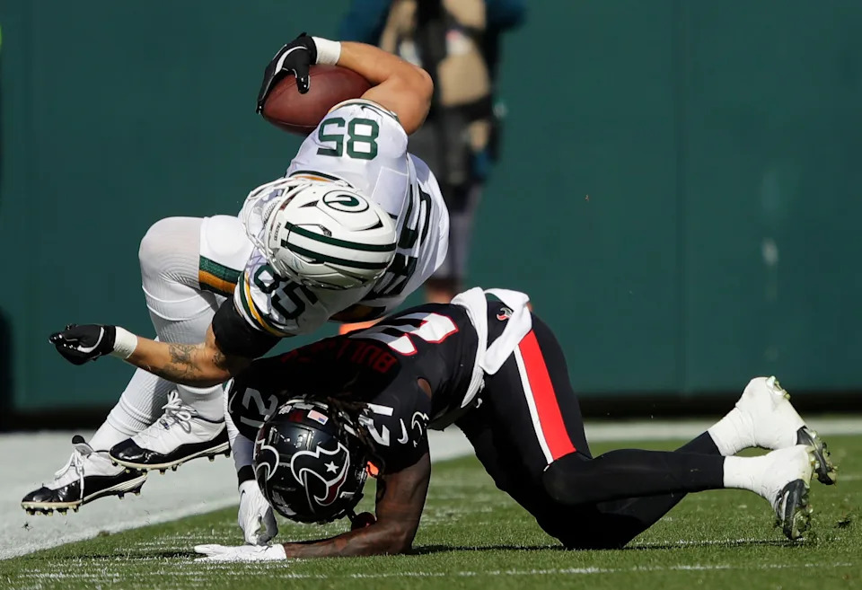 Oct 20, 2024; Green Bay, Wisconsin, USA; Green Bay Packers tight end Tucker Kraft (85) gets a first down reception against Houston Texans safety Calen Bullock (21) during their football game Sunday, October 20, 2024, at Lambeau Field in Green Bay, Wisconsin. Mandatory Credit: Dan Powers/USA TODAY Network via Imagn Images