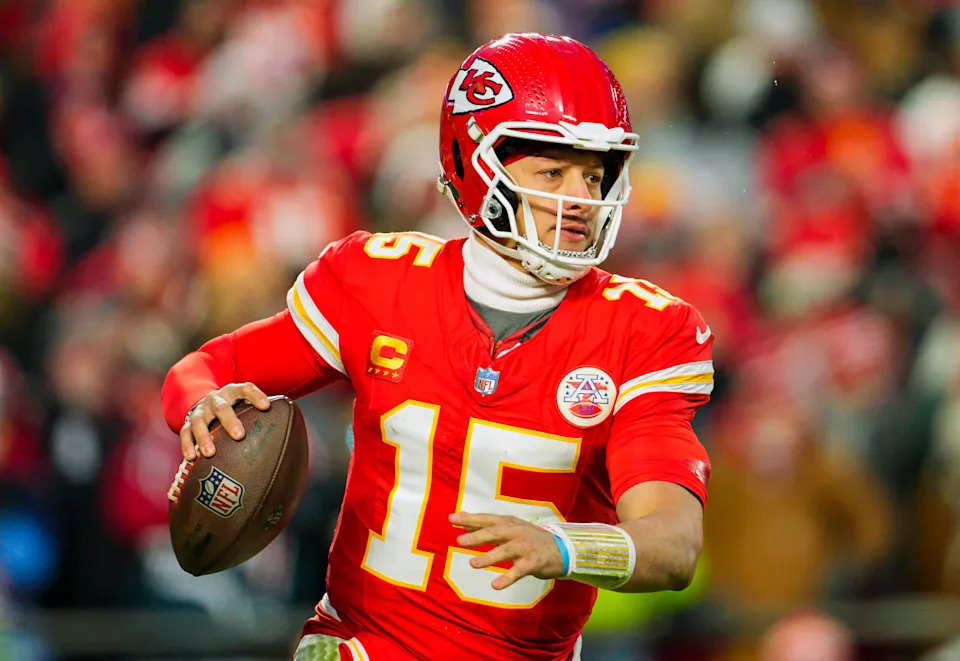 Kansas City Chiefs quarterback Patrick Mahomes (15) rolls out to pass during the second half against Houston Texans in a 2025 AFC divisional round game at GEHA Field at Arrowhead Stadium.