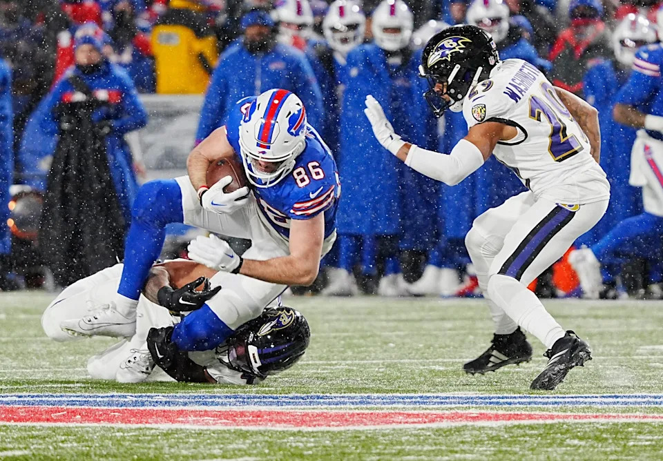 Buffalo Bills tight end Dalton Kincaid gets taken down by Baltimore Ravens linebacker Malik Harrison after catching a pass for a first down during first half action at the Buffalo Bills divisional game against the Baltimore Ravens at Highmark Stadium in Orchard Park on Jan. 19, 2025.
