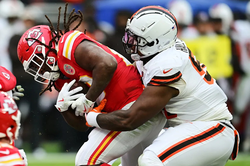Cleveland Browns defensive tackle Mike Hall Jr. (51) tackles Kansas City Chiefs running back Kareem Hunt (29) on Dec. 15, 2024, in Cleveland, Ohio.