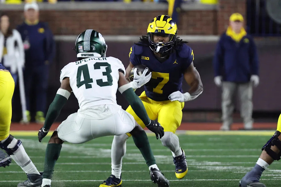 Michigan Wolverines running back Donovan Edwards rushes at Michigan State Spartans defensive back Malik Spencer.