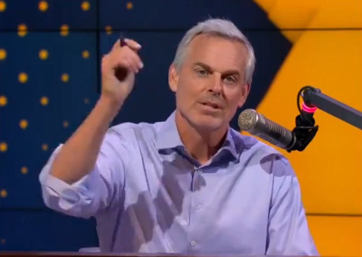 Colin Cowherd speaking into a microphone.