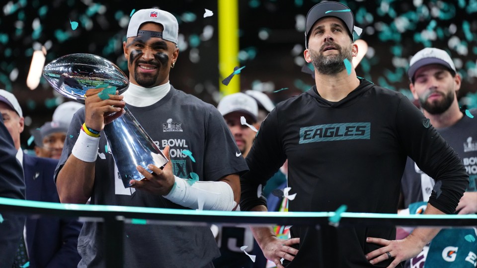 Jalen Hurts and Nick Sirianni celebrating Super Bowl victory with the Lombardi Trophy.