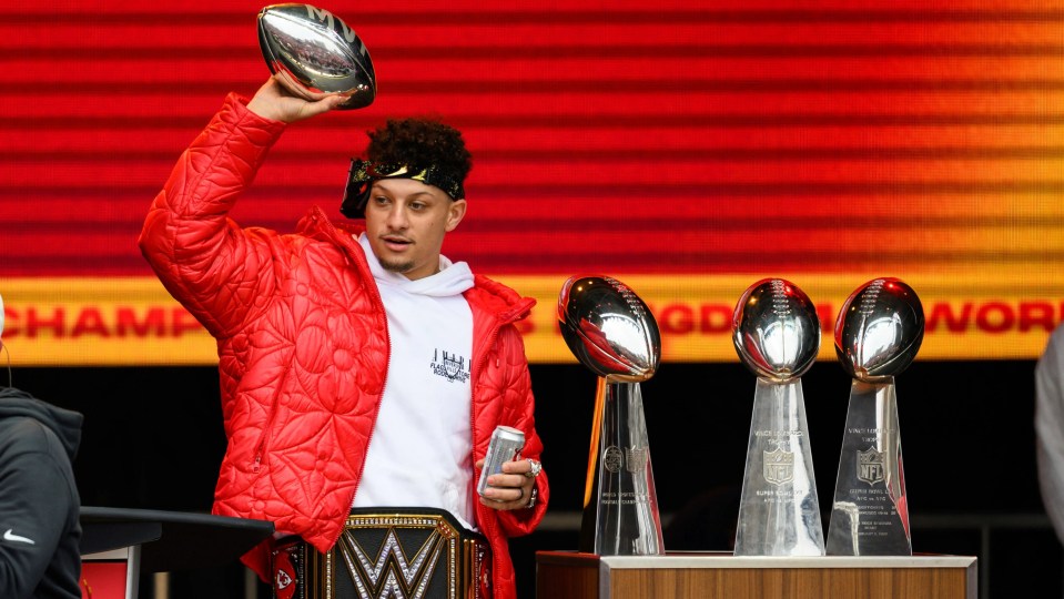 Patrick Mahomes holding a silver MVP football at a celebration.