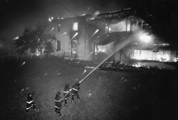 The first of what would become more than 150 firefighters battle a five-alarm blaze in the Post and Paddock Club at Arlington Park on July 31, 1985. (Paul F. Gero/Chicago Tribune)