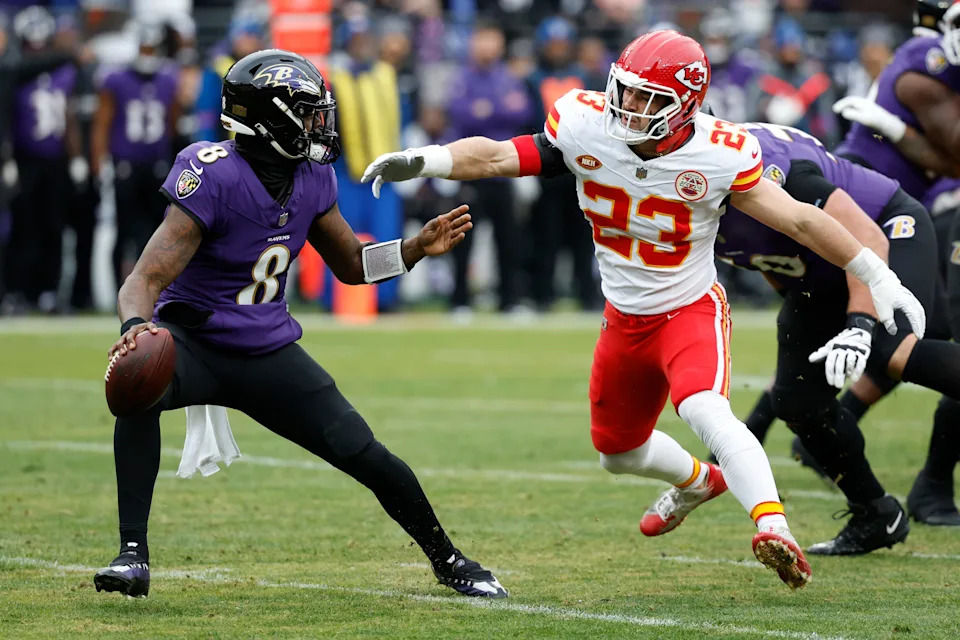 Jan 28, 2024; Baltimore, Maryland, USA; Kansas City Chiefs linebacker Drue Tranquill (23) chases Baltimore Ravens quarterback Lamar Jackson (8) in the AFC Championship football game at M&T Bank Stadium. Mandatory Credit: Geoff Burke-USA TODAY Sports
