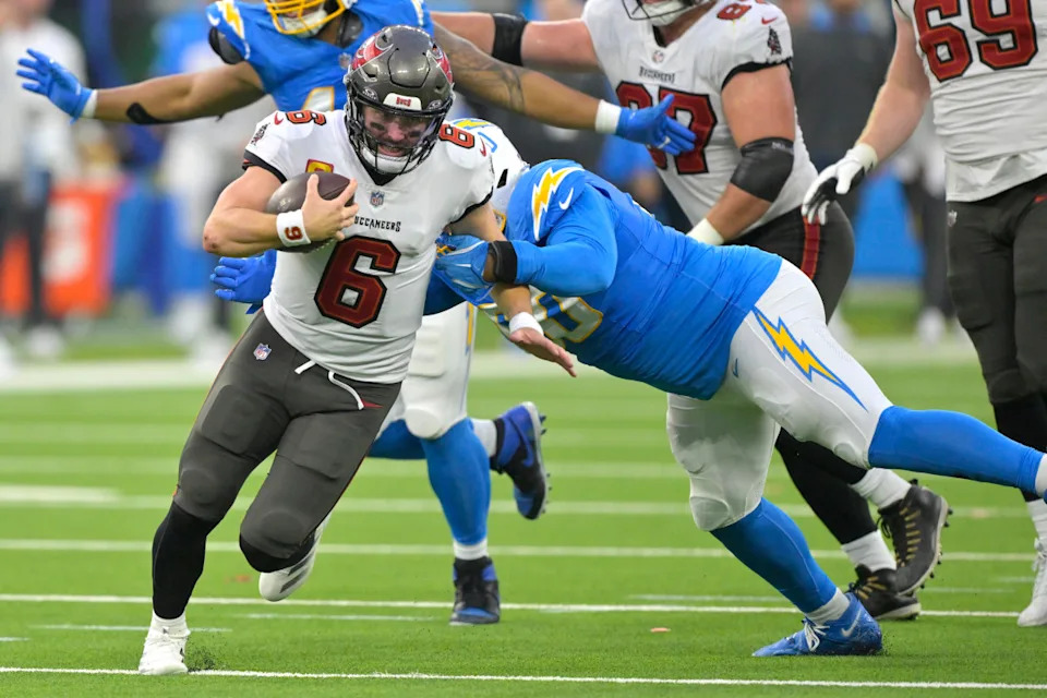 Dec 15, 2024; Inglewood, California, USA; Tampa Bay Buccaneers quarterback Baker Mayfield (6) runs the ball ipast Los Angeles Chargers defensive tackle Teair Tart (90) in the second half at SoFi Stadium.© Jayne Kamin-Oncea-Imagn Images