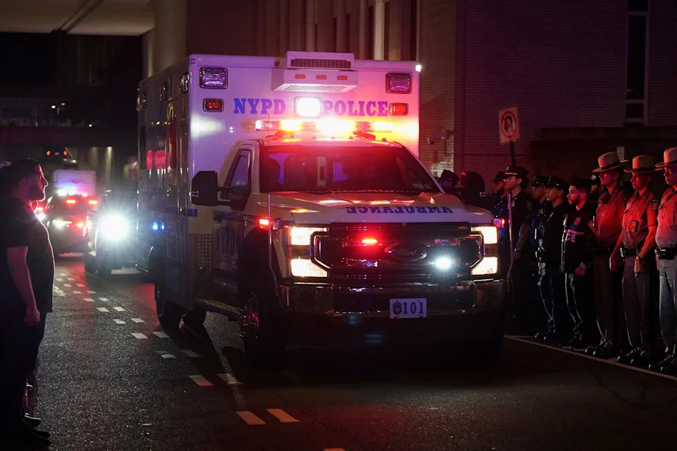 Bing Guan/Reuters - PHOTO: NYPD officers and other police officers wait for the ambulance transfer of slain NYPD officer Didarul Islam in New York City, U.S., July 29, 2025.