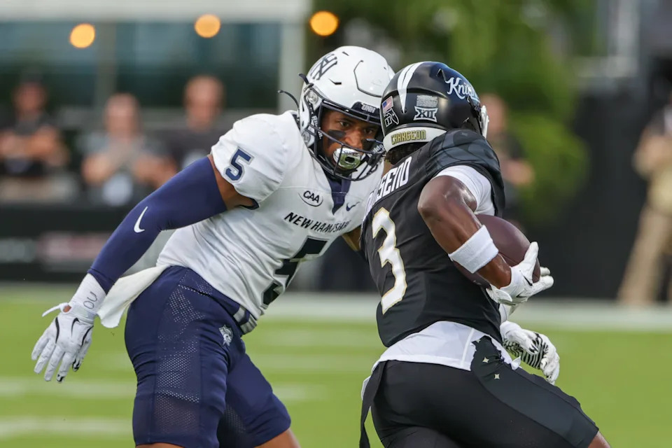 Aug 29, 2024; Orlando, Florida, USA; New Hampshire Wildcats defensive back Wande Owens (5) moves in on UCF Knights wide receiver Xavier Townsend (3) during the first quarter at FBC Mortgage Stadium. Mandatory Credit: Mike Watters-USA TODAY Sports