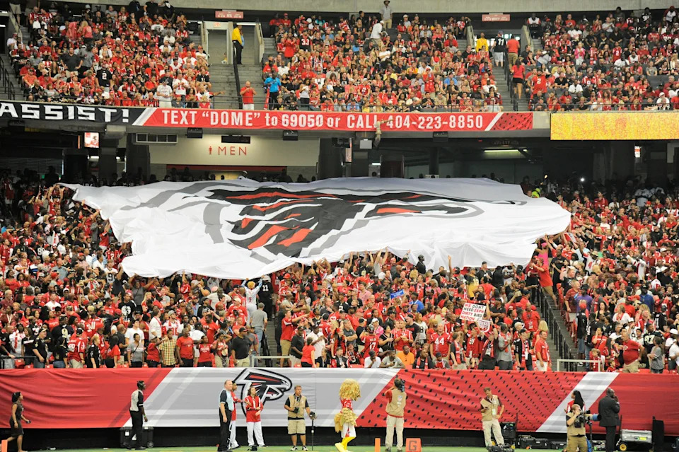 Sep 7, 2014; Atlanta, GA, USA; Atlanta Falcons fans pass a logo flag across the stands during the game against the New Orleans Saints during the second half at the Georgia Dome. The Falcons defeated the Saints 37-34 in overtime. Mandatory Credit: Dale Zanine-USA TODAY Sports