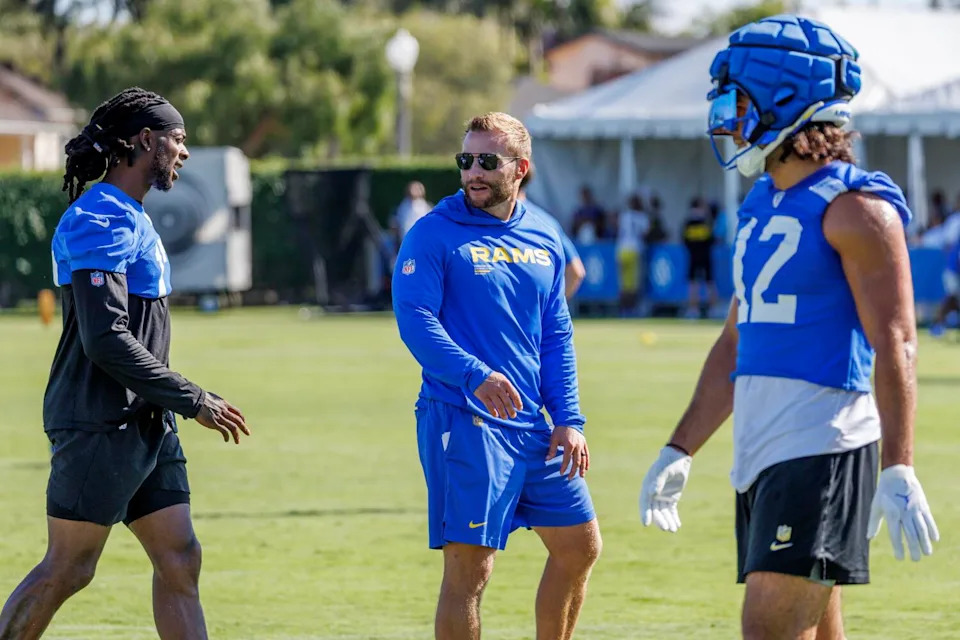 Rams coach Sean McVay chats with wide receiver Davante Adams, left, as wide receiver Puka Nacua walks by.