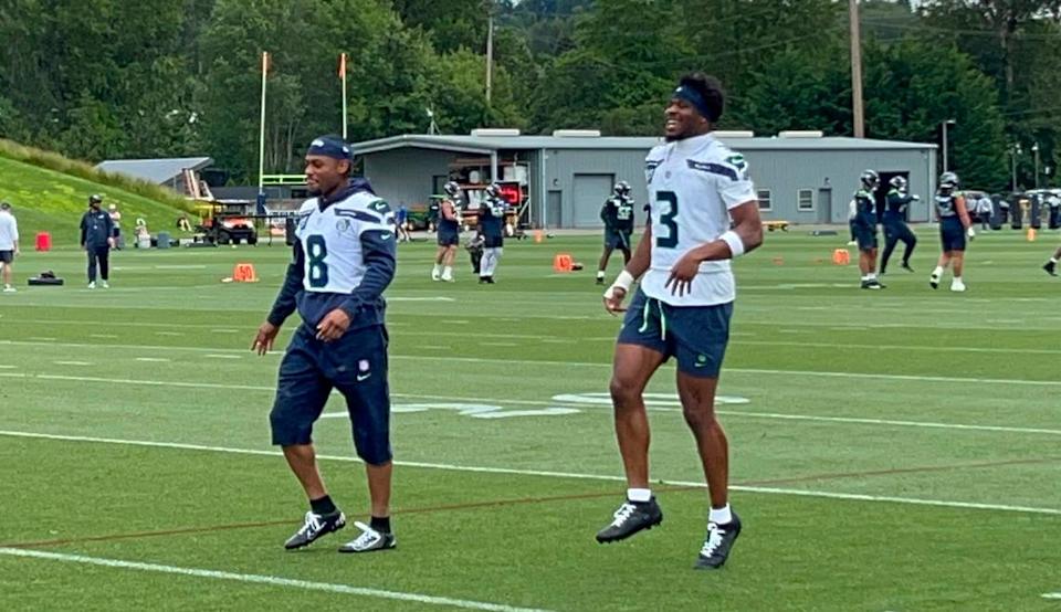 Veteran safety Coby Bryant (8) and rookie second-round NFL draft choice Nick Emmanwori (3) joke during their warmups for the fifth practice of Seattle Seahawks organized team activities (OTAs) June 4, 2025, at the Virginia Mason Athletic Center in Renton. Gregg Bell/The News Tribune