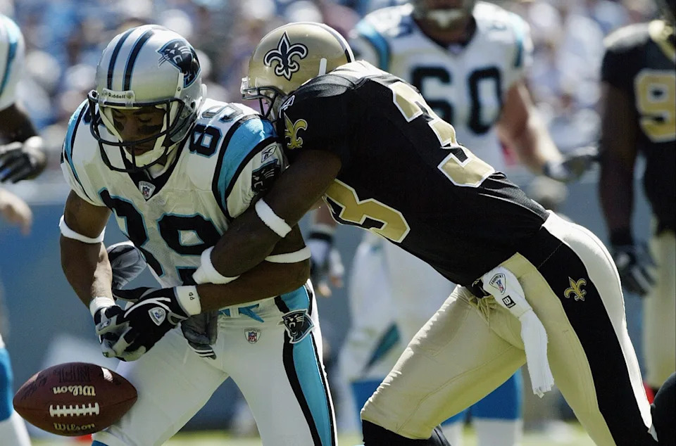 CHARLOTTE, NC - OCTOBER 5: Steve Smith #89 of the Carolina Panthers has a pass broken up by Ashley Ambrose #33 of the New Orleans Saints on October 5, 2003 at Ericsson Stadium in Charlotte, North Carolina. The Panthers defeated the Saints 19-13. (Photo by Craig Jones/Getty Images)