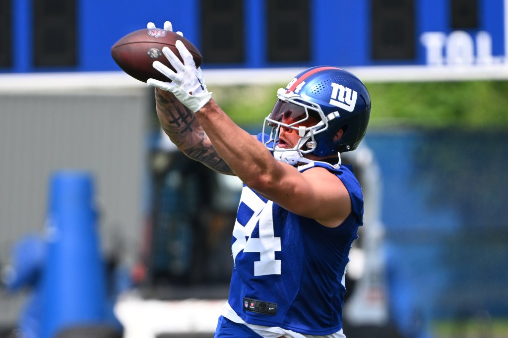 New York Giants tight end Theo Johnson catching a football during practice.