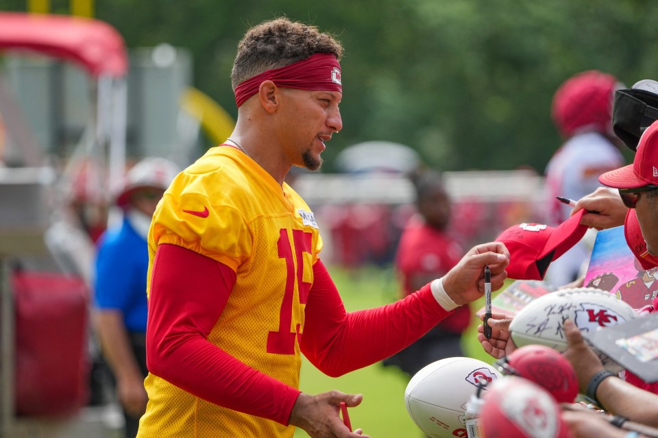 Patrick Mahomes signing autographs for fans.