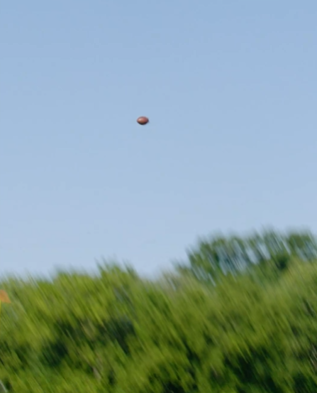 The ball flew through the air before landing down the field