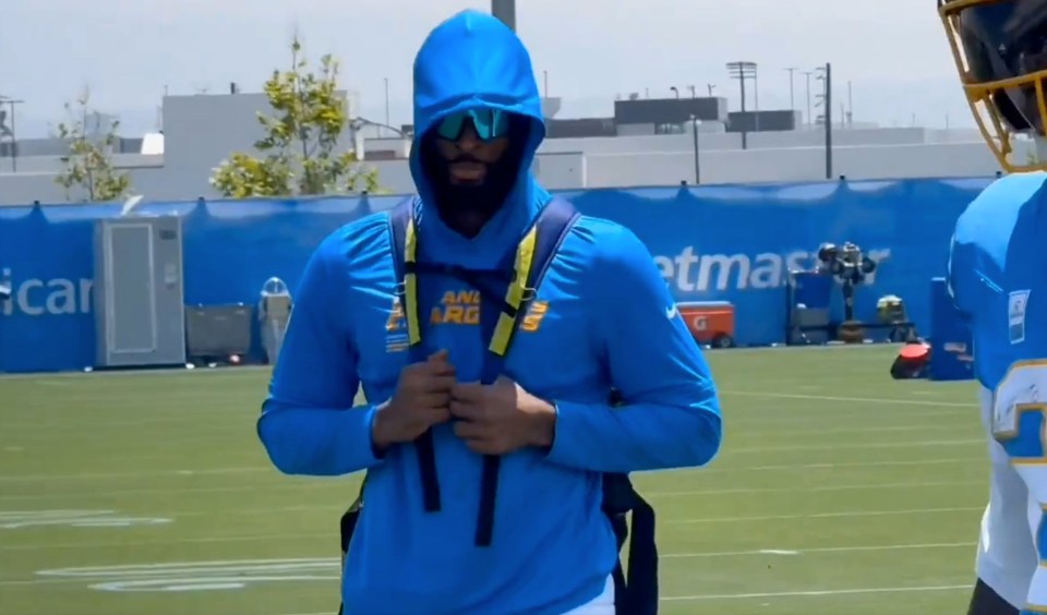 Najee Harris at Chargers training, wearing a blue hoodie.