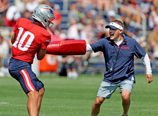 Quarterback Drake Maye of the New England Patriots and offensive coordinator Josh McDaniels during  a training camp drill in Foxboro on Tuesday. (Photo By Matt Stone/Boston Herald)