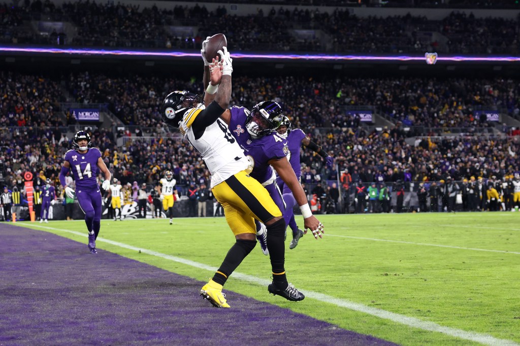 Cordarrelle Patterson #84 of the Pittsburgh Steelers catches a touchdown pass while defended by Malik Harrison #40 of the Baltimore Ravens during the third quarter at M&T Bank Stadium on December 21, 2024 in Baltimore, Maryland. 
