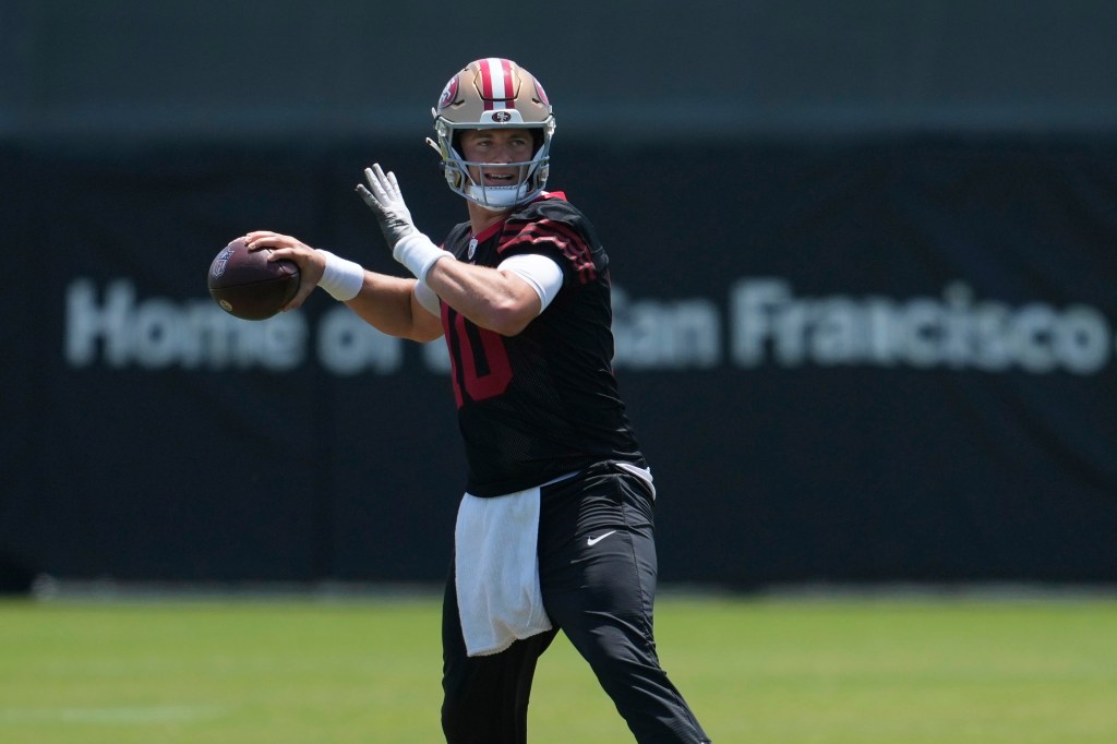 Mac Jones, San Francisco 49ers quarterback, throwing a football.