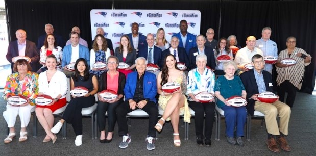 New England Patriots Chair and CEO Robert Kraft, front row fifth from left, takes a group photo with the 2025 Myra Kraft Community MVP Award winners on June 3 at Gillette Stadium in Foxborough. (COURTESY ERIC J. ADLER/NEW ENGLAND PATRIOTS)