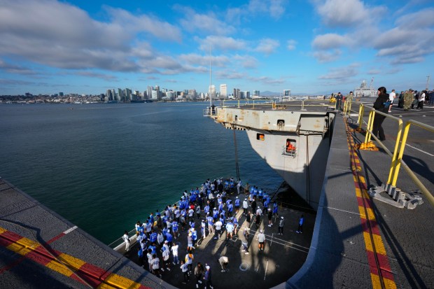 Players from the Los Angeles Chargers take an elevator ride up to the flight deck of the USS Abraham Lincoln (CVN 72).  (Nelvin C. Cepeda / The San Diego Union-Tribune)