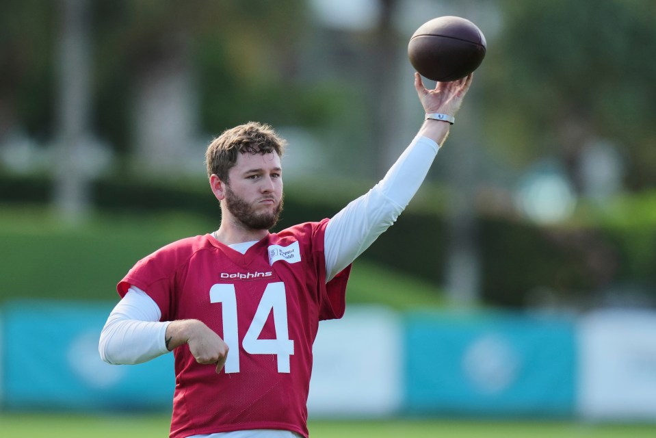 Miami Dolphins quarterback Quinn Ewers throwing a football at practice.