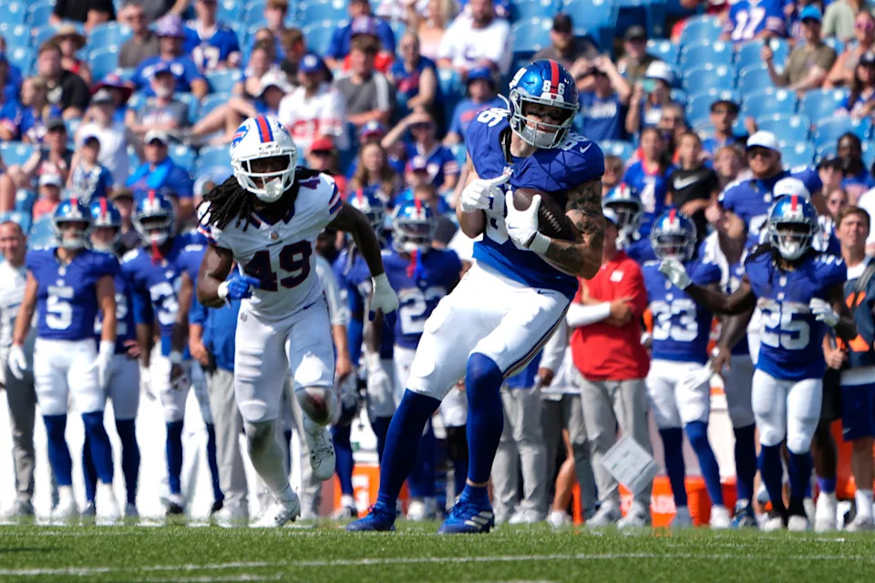 Aug 9, 2025; Orchard Park, New York, USA; New York Giants tight end Thomas Fidone II (86) runs with the ball after making a catch against Buffalo Bill linebacker Keonta Jenkins (49) during the second half at Highmark Stadium. Mandatory Credit: Gregory Fisher-Imagn Images