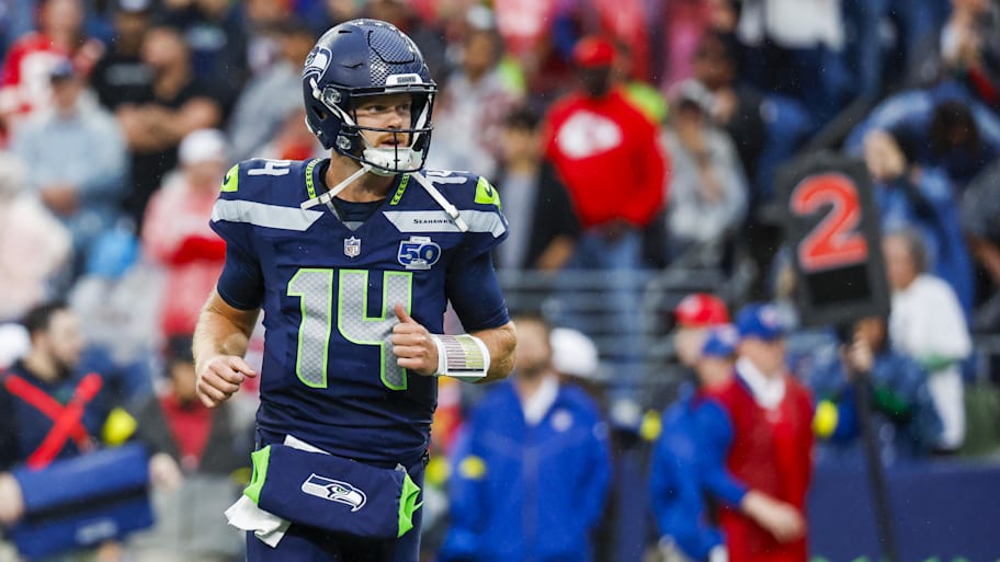 Sam Darnold runs onto the field in a Seahawks uniform