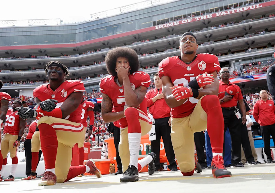 FILE - In this Oct. 2, 2016, file photo, from left, San Francisco 49ers outside linebacker Eli Harold, quarterback Colin Kaepernick and safety Eric Reid kneel during the national anthem before an NFL football game against the Dallas Cowboys in Santa Clara, Calif. During an appearance on Fox News Jan. 3, 2017, former Redskins quarterback Joe Theismann slammed the 49ers' decision to give Kaepernick an award for being an “inspirational and courageous” player. (AP Photo/Marcio Jose Sanchez, File)