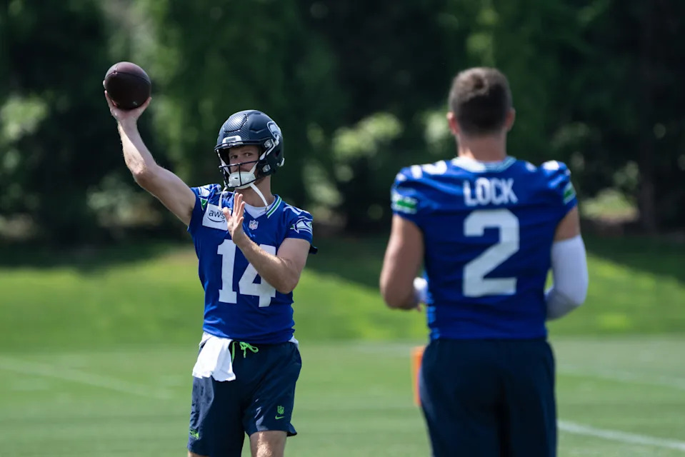 Jun 11, 2025; Renton, WA, USA; Seattle Seahawks quarterback Sam Darnold (14) passes the ball to quarterback Drew Lock (2) during mini-camp at Virginia Mason Athletic Center. Mandatory Credit: Stephen Brashear-Imagn Images