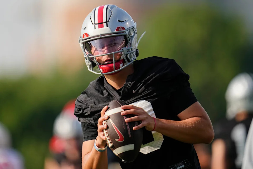 Ohio State Buckeyes quarterback Julian Sayin (10) takes a snap during football training camp at the Woody Hayes Athletic Center on Aug. 1, 2025.