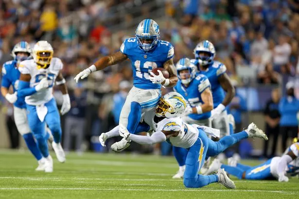 Los Angeles Chargers safety RJ Mickens (27) tackles Detroit Lions running back Craig Reynolds (13) during the second quarter of the National Football League preseason game between the Los Angeles Chargers and Detroit Lions on July 31, 2025, at the Tom Benson Hall of Fame Stadium in Canton, OH