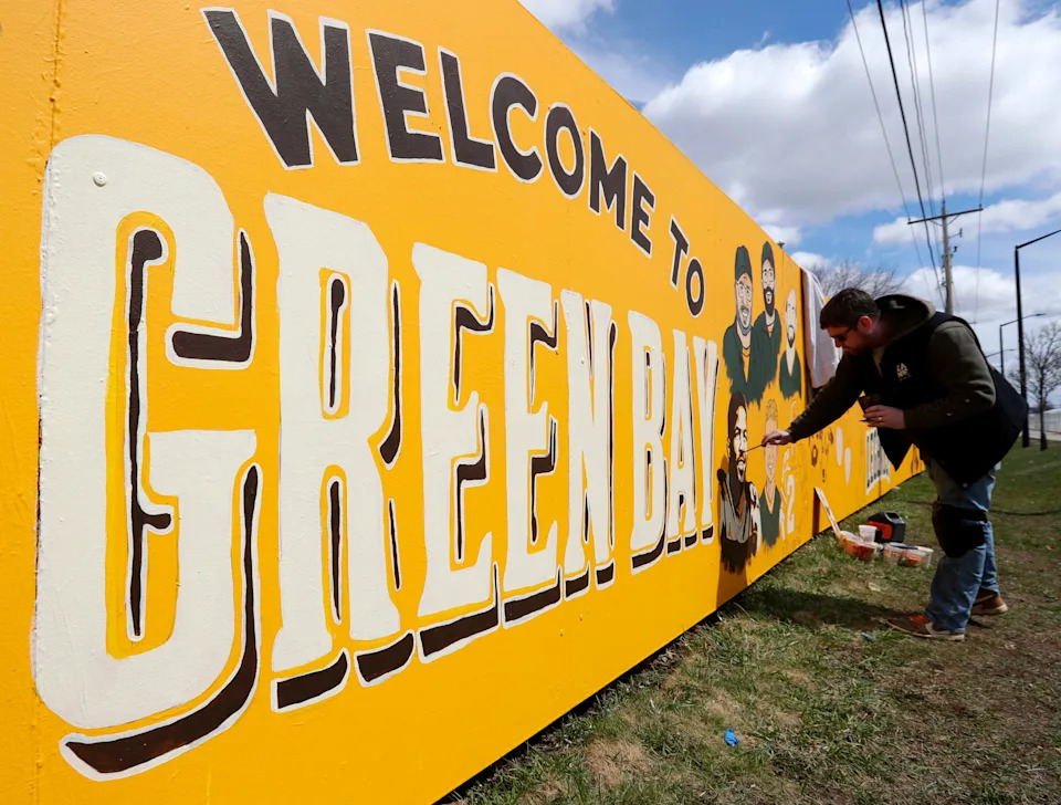 Artist Zane Statz paints the Packers fence at 1267 Shadow Lane for the 2025 NFL Draft on April 19 in Green Bay.