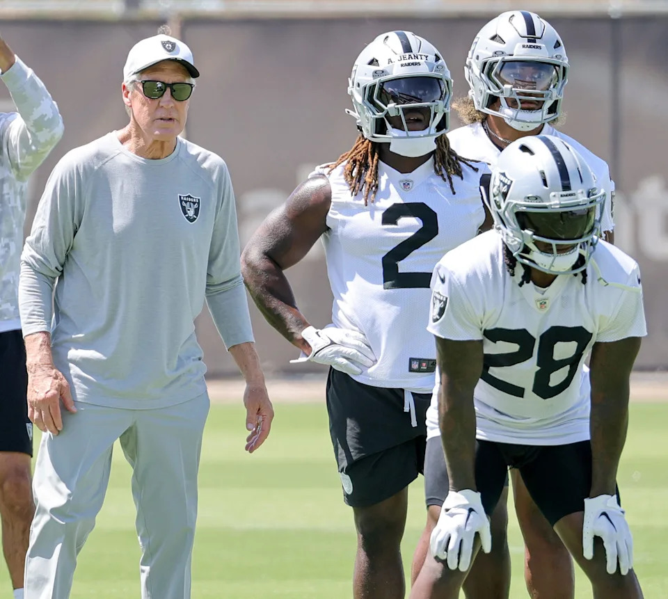 Head coach Pete Carroll of the Las Vegas Raiders looks on as Sincere McCormick #28, Ashton Jeanty #2 and Chris Collier #33 run through a drill during an OTA offseason workout at the Las Vegas Raiders Headquarters/Intermountain Healthcare Performance Center.