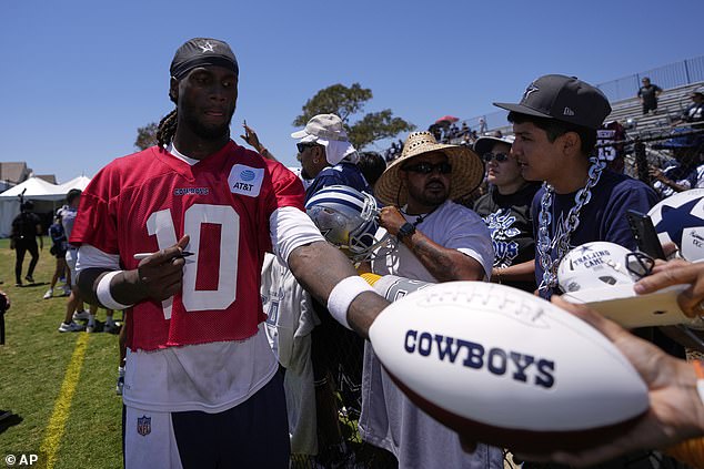 Cowboys quarterback Joe Milton III signs autographs during training camp