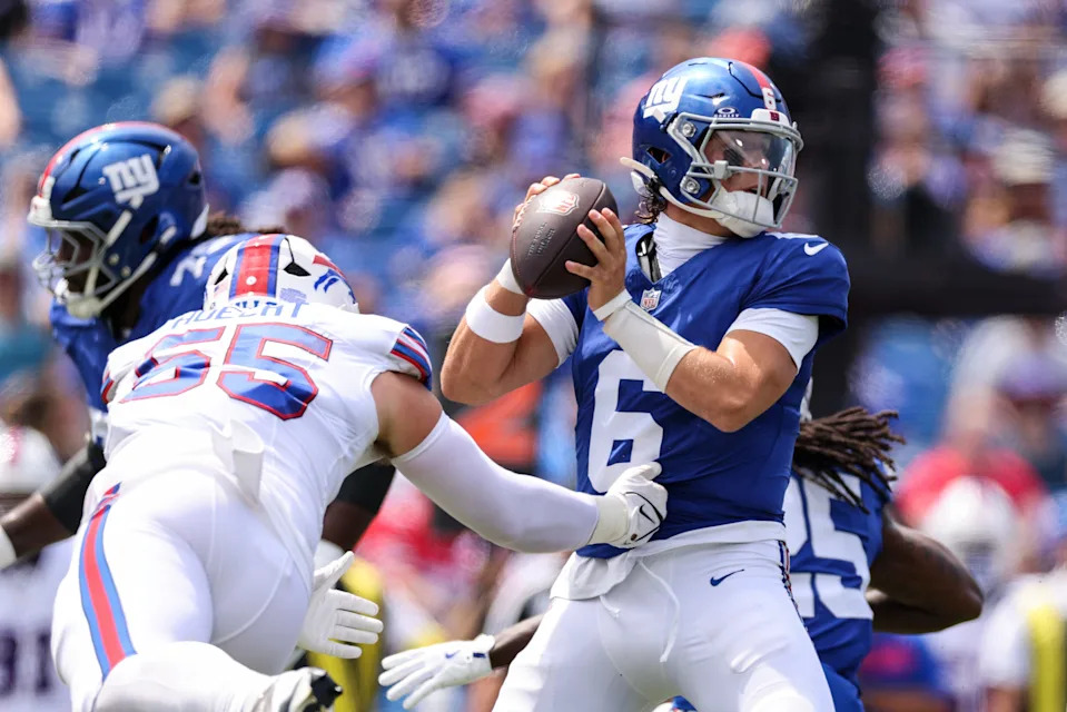 ORCHARD PARK, NEW YORK - AUGUST 09: Michael Hoecht #55 of the Buffalo Bills attempts to tackle Jaxson Dart #6 of the New York Giants during the first quarter of an NFL Preseason 2025 game between New York Giants and Buffalo Bills at Highmark Stadium on August 09, 2025 in Orchard Park, New York. (Photo by Bryan M. Bennett/Getty Images)