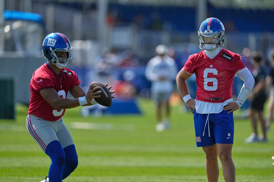 New York Giants quarterback Jaxson Dart, right, watches as Russell Wilson prepares to throw during a practice at the team's NFL football training camp in East Rutherford, N.J., Thursday, July 24, 2025. (AP Photo/Seth Wenig)