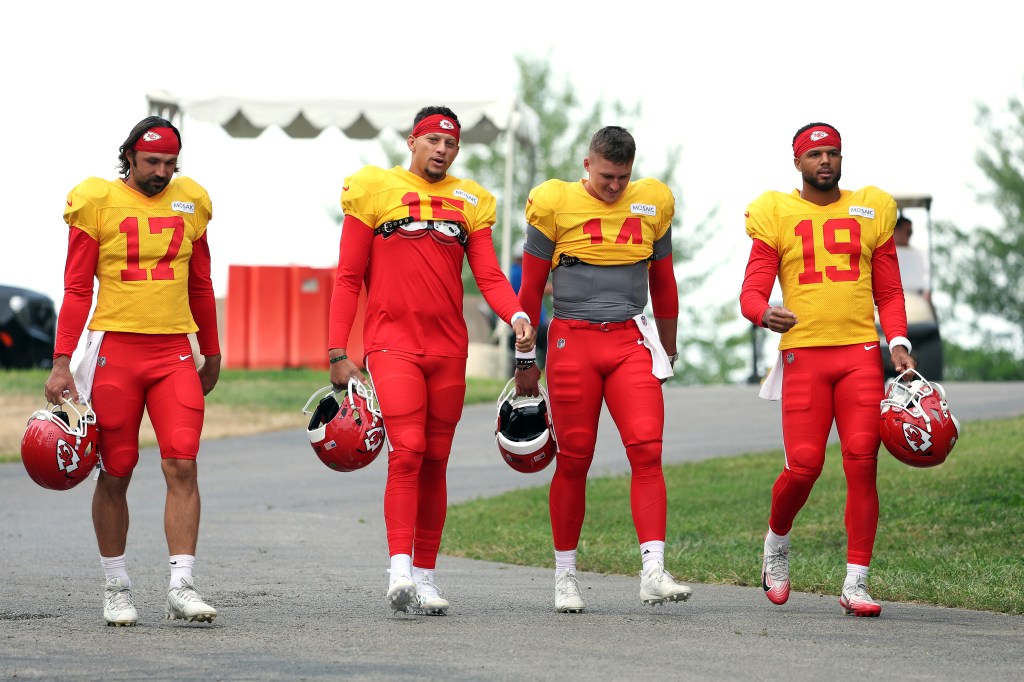 Four Kansas City Chiefs quarterbacks walking to practice.