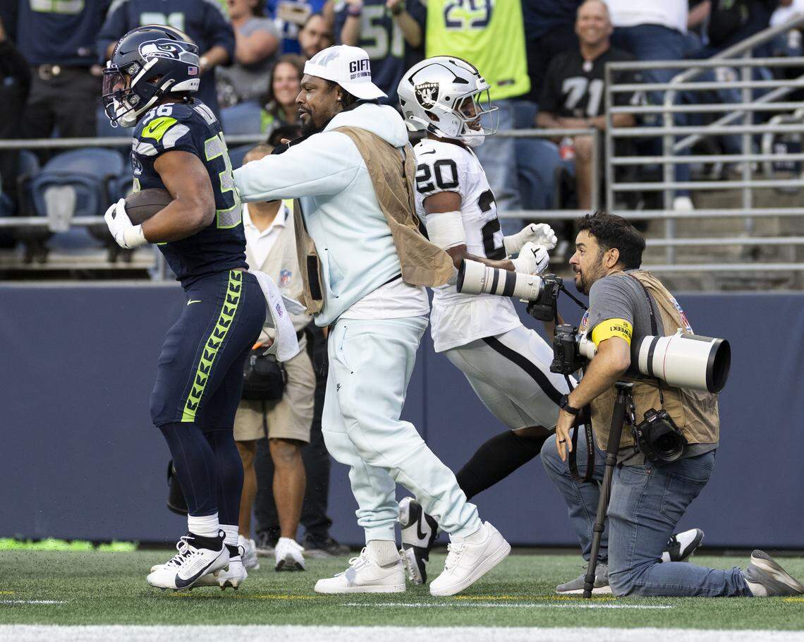 Seattle Seahawks running back George Holani (36) bounces off former Seahawks running back Marshawn Lynch after scoring a touchdown during the first quarter of the game against the Las Vegas Raiders at Lumen Field, on Thursday, Aug. 7, 2025, in Seattle, Wash. Brian Hayes/bhayes@thenewstribune.com