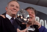 Dallas Cowboys owner and general manager Jerry Jones hoists the Super Bowl trophy alongside...