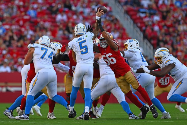 San Francisco 49ers' Trevis Gipson (56) breaks up a pass as he swats the arm of Los Angeles Chargers quarterback Trey Lance (5) in the first quarter of their NFL preseason game at Levi's Stadium in Santa Clara, Calif., on Saturday, Aug. 23, 2025. (Jose Carlos Fajardo/Bay Area News Group)
